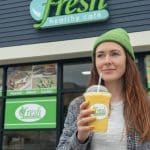 woman standing casually outside Fresh Healthy Café